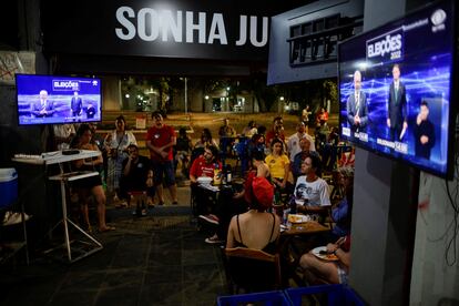 Los parroquianos de un bar siguen este domingo la retransmisión del debate entre Lula da Silva y Bolsonaro.