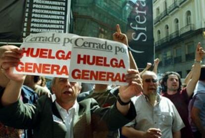 Un grupo de personas reivindica la huelga ante un centro comercial en el centro de Madrid.