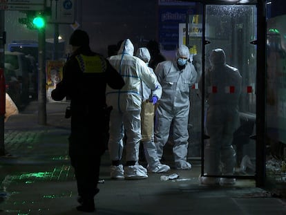 Investigators and forensic experts stand outside a Jehovah's Witness building in Hamburg, Germany Friday, March 10, 2023. Shots were fired inside the building used by Jehovah's Witnesses in the northern German city of Hamburg on Thursday evening, with multiple people killed and wounded, police said. (Steven Hutchings/Tnn/dpa via AP)