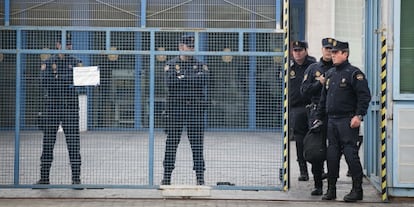 Police officers stand at the entrance of the immigrant holding center in Barcelona.