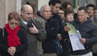 Jobseekers wait in line outside a Madrid unemployment office.