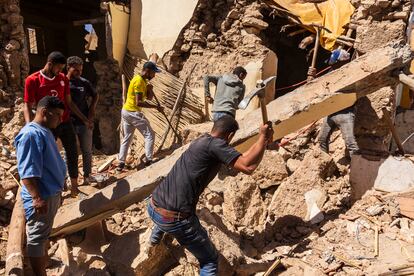Said and his crew work to clear debris from the remains of the kitchen in Ahmed's house. 