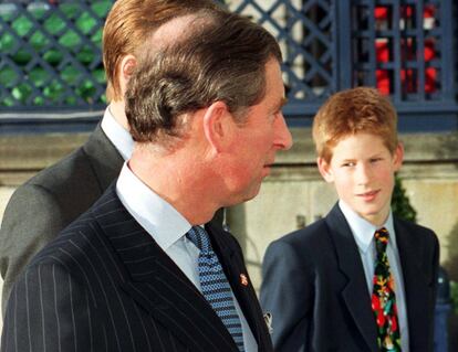 El principe de Gales, Carlos de Inglaterra (C), y sus hijos, el príncipe Enrique (I), y el príncipe Guillermo (detrás), a su llegada  a la fiesta anual que el príncipe de Gales ofrece a sus colaboradores en el Hotel Ritz de Londres, el 16 de diciembre de 1998.