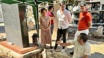 María José Berlanga, a la izquierda, atiende las explicaciones de las personas que han intervenido en el camposanto en una imagen cedida por los investigadores.
