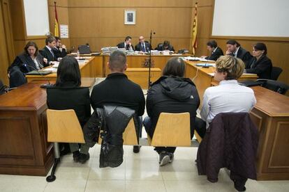 A la izquierda, los dos agentes de los Mossos d'Esquadra acusados. A la derecha (camisa blanca), el joven que presuntamente sufrió las vejaciones.