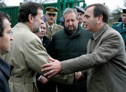 El ministro de Defensa, José Antonio Alonso saluda al presidente del PP, Mariano Rajoy, en presencia deL alcalde de Lugo, Xosé Lopez Orozco (en el centro), y del presidente del PP de Galicia, Alberto Nuñez (izquierda), antes del funeral.