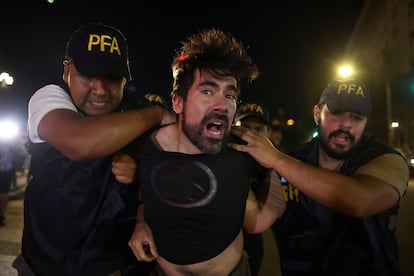 Police officers detain a demonstrator during a protest as lawmakers debate on Argentina's President Javier Milei's economic reform bill