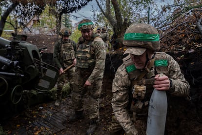 A Ukrainian serviceman carries a projectile to fire towards Russian positions in the Kharkiv region, Ukraine, Wednesday, Oct. 16, 2024.