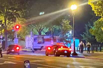 A box truck is seen crashed into a security barrier at a park across from the White House, Monday night, Washington