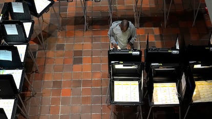 A man casts a ballot on the first day of early voting in in Miami, Florida on October 21, 2024.