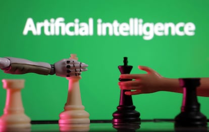 Words reading "Artificial intelligence", miniature of robot and toy hand are pictured in this illustration taken December 14, 2023.
