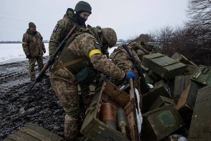Ukrainian servicemen inspect ammunitions from destroyed military vehicles in the Sumy region