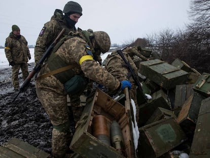 Ukrainian servicemen inspect ammunitions from destroyed military vehicles in the Sumy region