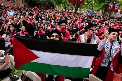 A graduate displays a Palestinian flag during the 373rd Commencement at Harvard University