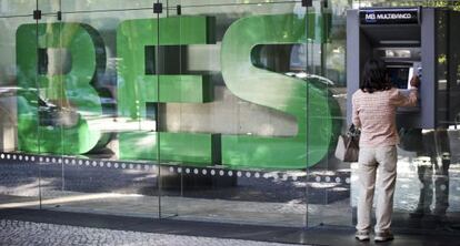 Una mujer utiliza un cajero automático en la sede del Banco Espirito Santo en Lisboa.