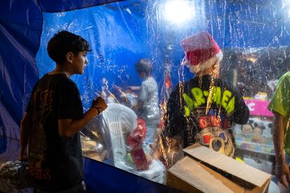 Un niño en la espera del reparto de regalos de Navidad durante la celebración de Nochebuena frente al Congreso.