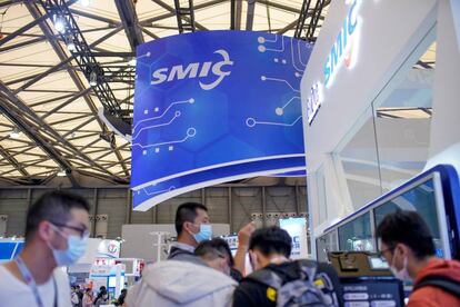 FILE PHOTO: People visit a booth of Semiconductor Manufacturing International Corporation (SMIC), at China International Semiconductor Expo (IC China 2020) in Shanghai, China October 14, 2020. REUTERS/Aly Song/File Photo