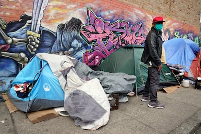 Sotero Cirilo stands near the tent where he sleeps next to other homeless people in the Queens borough of New York