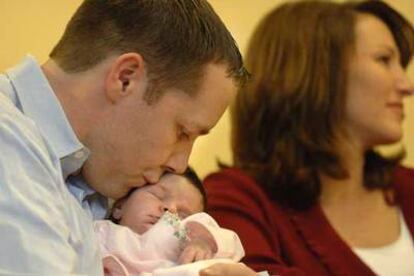 El padre de Grace VanDerwerken, Jay VanDerwerken, le da un beso mientras que la madre da una rueda de prensa en el Hospital Infantil de Boston.