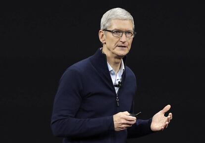 FILE- In this Sept. 12, 2017, file photo, Apple CEO Tim Cook, shows new Apple Watch Series 3 product at the Steve Jobs Theater on the new Apple campus in Cupertino, Calif. Cook is leaving shareholders in suspense about whether the iPhone maker will use its windfall from a tax cut on overseas profits for a big boost to its quarterly dividend. (AP Photo/Marcio Jose Sanchez, File)