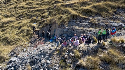 Arqueólogos forenses y familiares de desaparecidos se reúnen fuera de una cueva en el paraje Paccha Simi, en la sierra central de Perú.