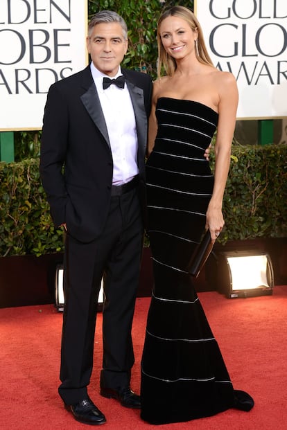 George Clooney, con pajarita y solapas de satén, vuelve a acompañarse de una espectacular novia. En esta alformbra roja le ha tocado el turno a Stacy Keibler, con un Armani Privé en palabra de honor.