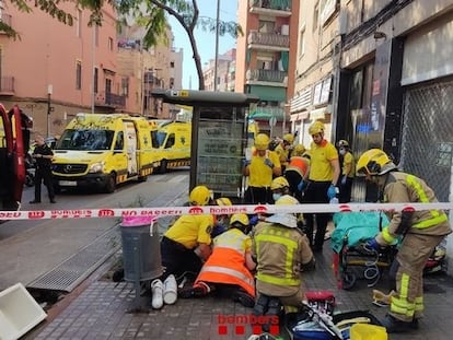 Los Bomberos y sanitarios atienden a los heridos por el incendio en un piso de Badalona (Barcelona).