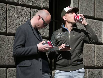 Dos turistes consumint un refresc ensucrat.