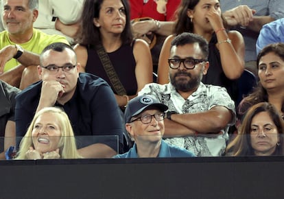 Bill Gates, seated next to Paula Hurd (right) at the match between Novak Djokovic and Stefanos Tsitsipas at the Australian Open on January 29.