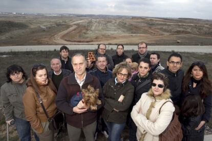 Members of co-ops managed by the administrator Ofigevi, pictured in front of the plots where their houses were meant to be built 10 years ago.