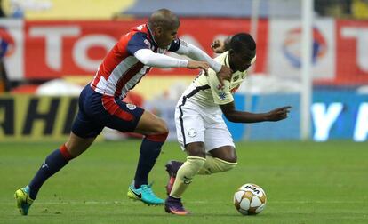 Salcido (i) va en busca del balón contra Quintero del América