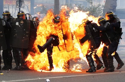 Agentes de la policía antidisturbios de Francia envueltos en llamas durante los enfrentamientos con los manifestantes en la marcha de los trabajadores por el Primero de Mayo en París.