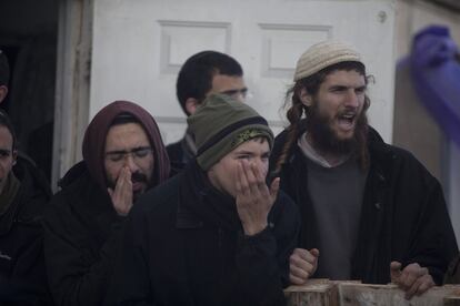 Colonos israelíes gritan a las fuerzas de seguridad israelíes a su llegada al asentamiento de Amona.