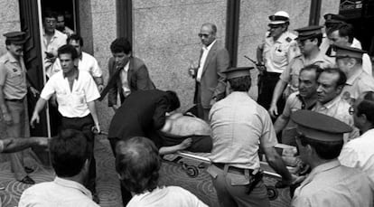 A pregnant woman is carried from the scene of the 1987 Hipercor bombing on a stretcher.