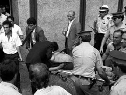 A pregnant woman is carried from the scene of the bombing on a stretcher.