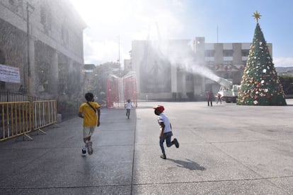 Los niños juegan mientras un camión sanitiza la plaza central de Chilpancingo, Guerrero, como medida de prevención de contagios de coronavirus.