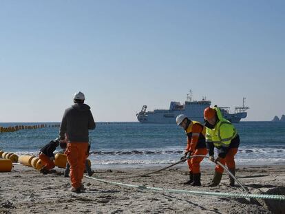 Orange Marine workers install an underwater cable between Singapore and France in March 2016.