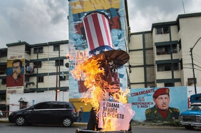 A giant effigy of President Obama burns on a street in Caracas.