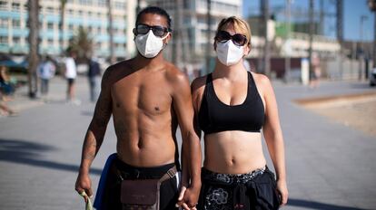 Two people wear face masks in Barcelona in May. 