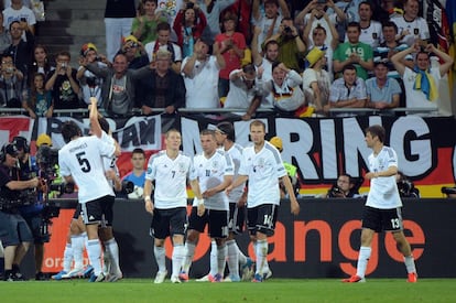 Los jugadores alemanes celebran el gol con los aficionados.