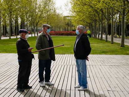 Men wearing face masks chat in the Lineal del Manzanares park in Madrid, in a file photo from March.