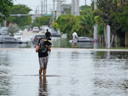 Una mujer camina en las calles inundadas de Miami-Dade el 13 de junio 2024.