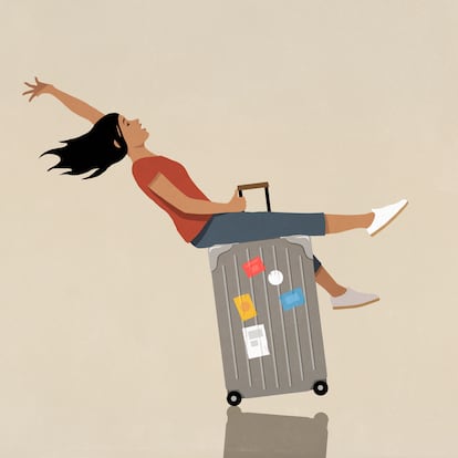 Carefree woman riding suitcase