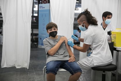 An adolescent receives his first shot of a Covid-19 vaccine in Barcelona.