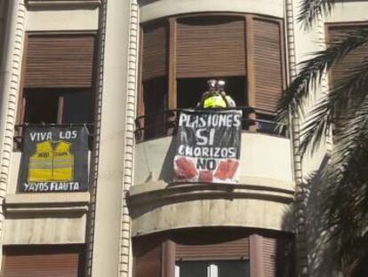 Un vecino de Valencia anima desde el balcón la manifestación en defensa de unas pensiones dignas.