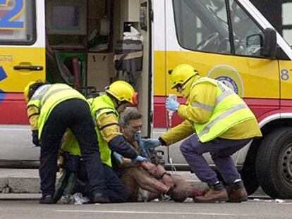 Un herido en la explosión de la estación de Atocha es atendido por personal sanitario.