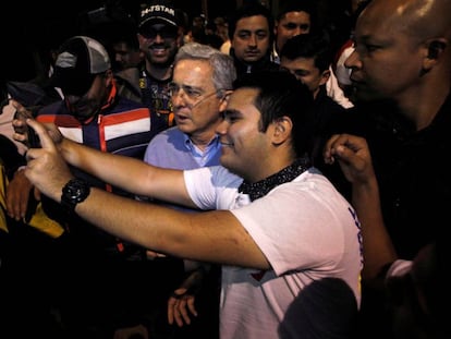 O ex-presidente colombiano Álvaro Uribe posa para um ‘selfie’ com um partidário do ‘não’ ao acordo de paz, no domingo.