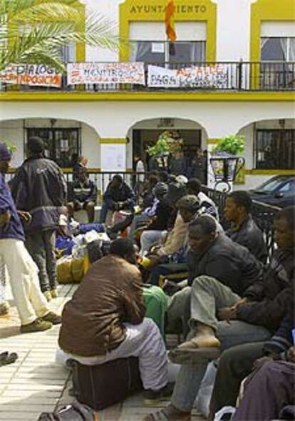 Inmigrantes concentrados en la plaza del Ayuntamiento de Palos de la Frontera.