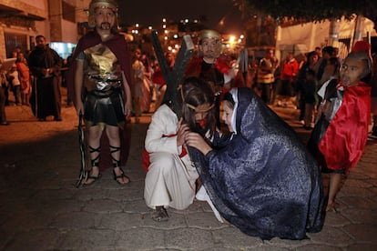 Unos niños participan en un viacrucis infantil en un barrio de Tegucigalpa