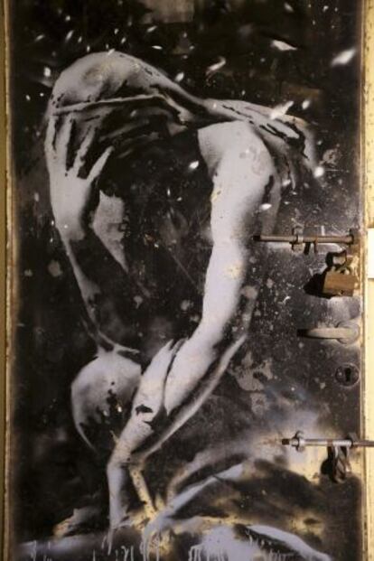 La puerta de metal con el grafiti de una diosa griega pintado por Banksy.